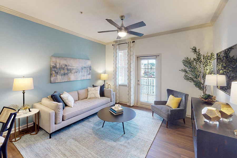 a living room with a couch and a ceiling fan