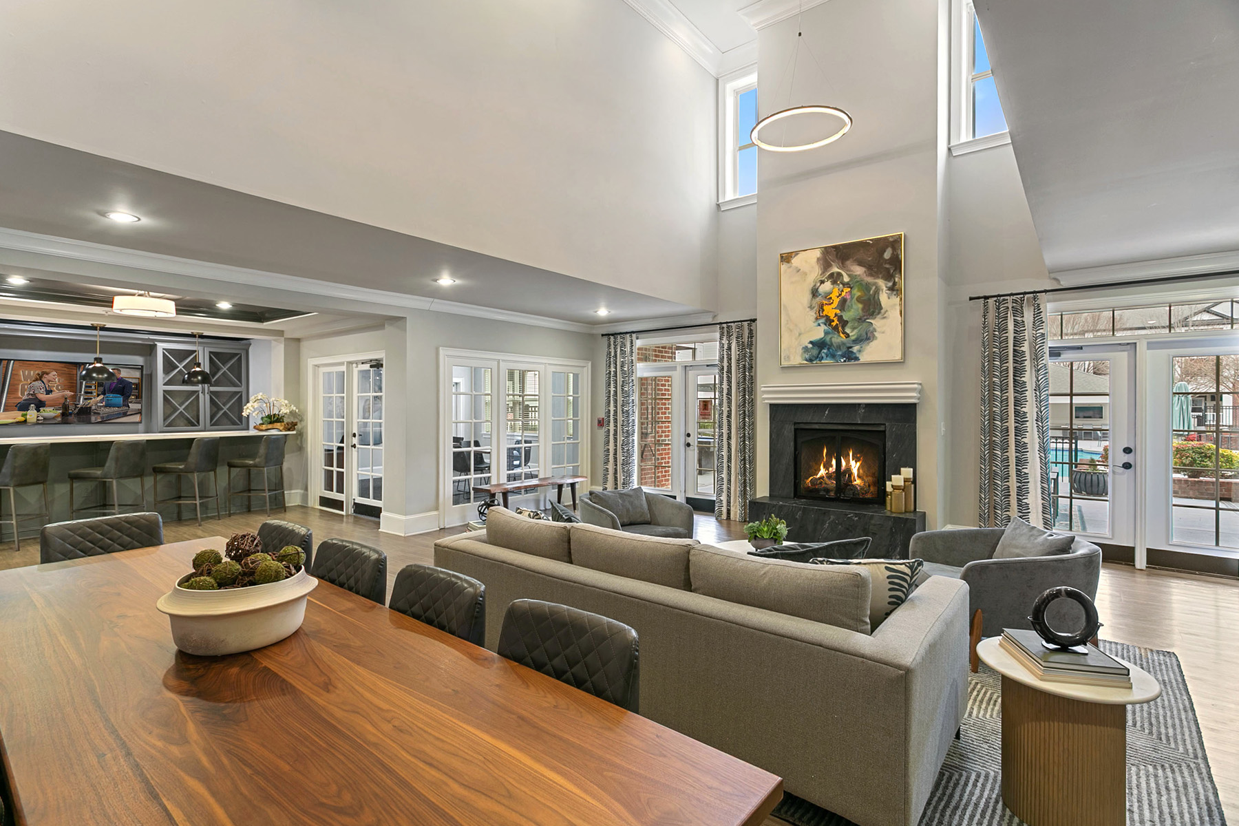 A modern living room with a fireplace and a painting on the wall.