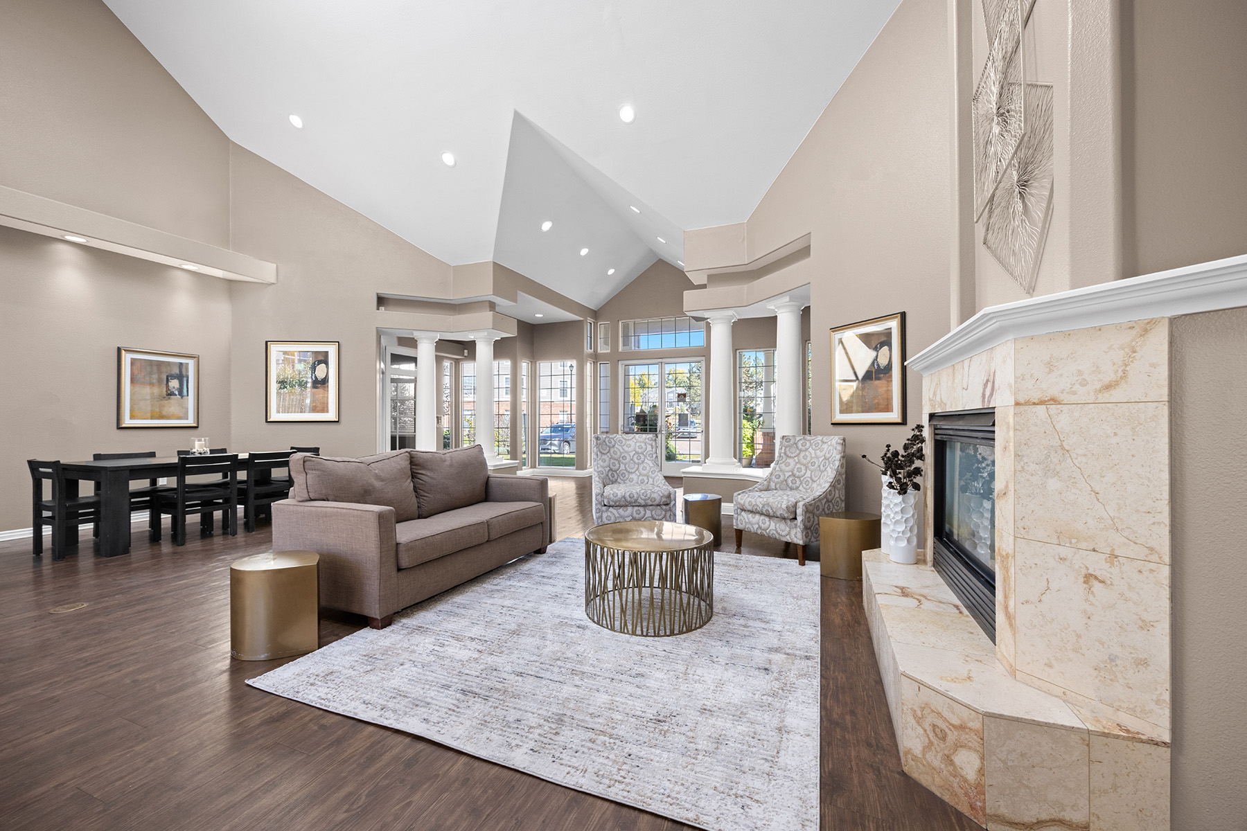 A living room with a large couch, a coffee table, and a fireplace.