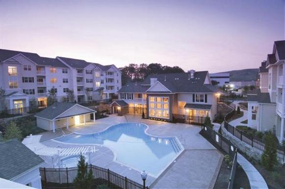 an aerial view of an empty swimming pool in an apartment building