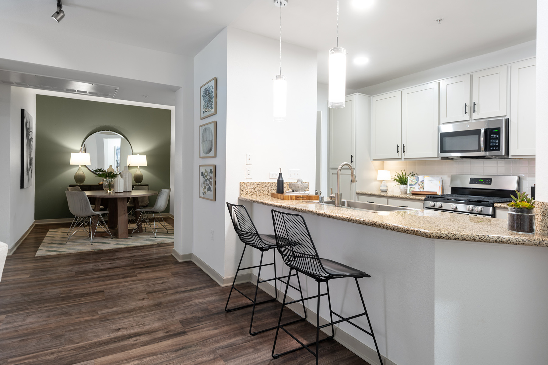 A kitchen with a dining table and chairs.