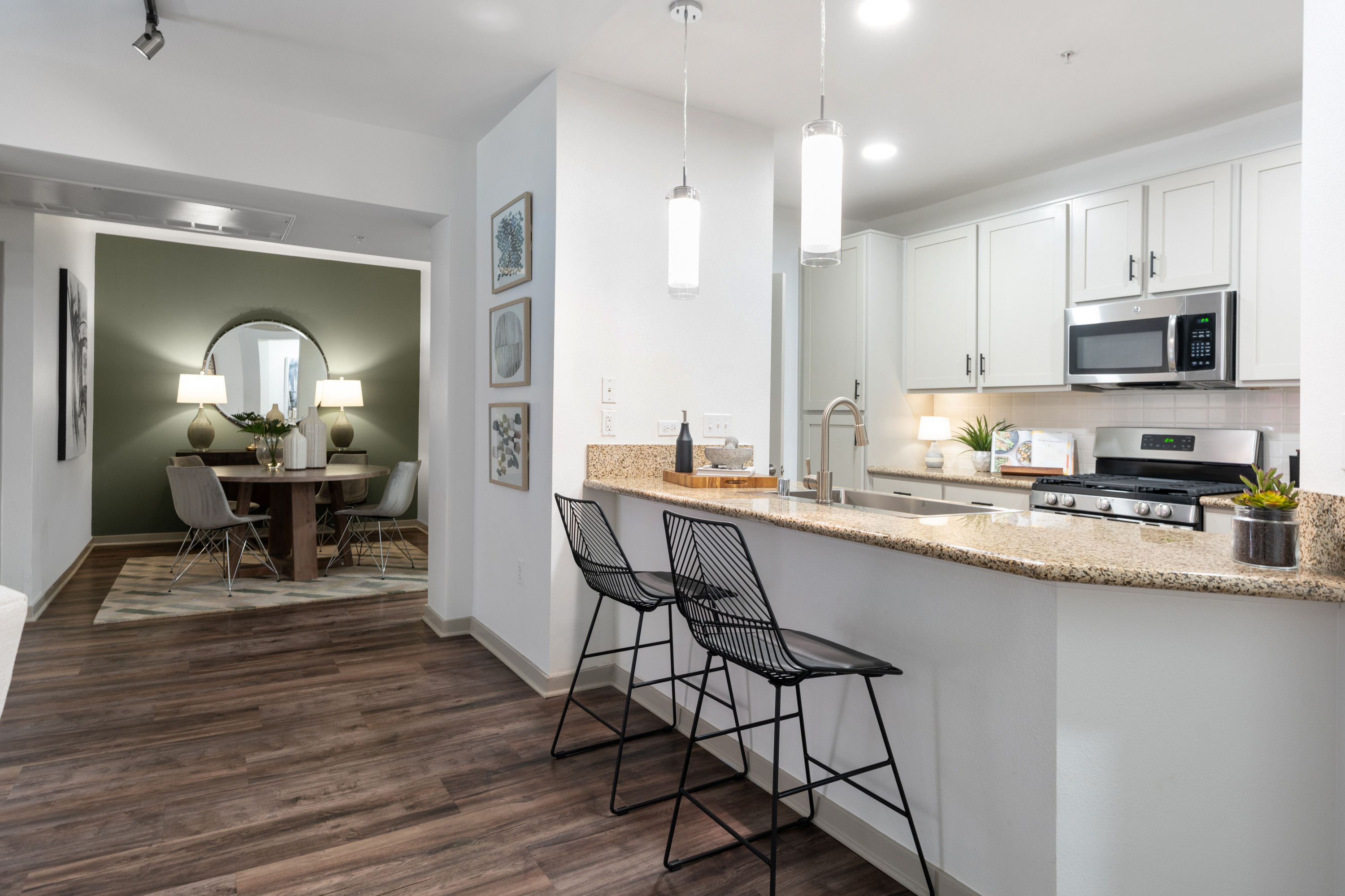 A kitchen with a black chair in front of a counter.