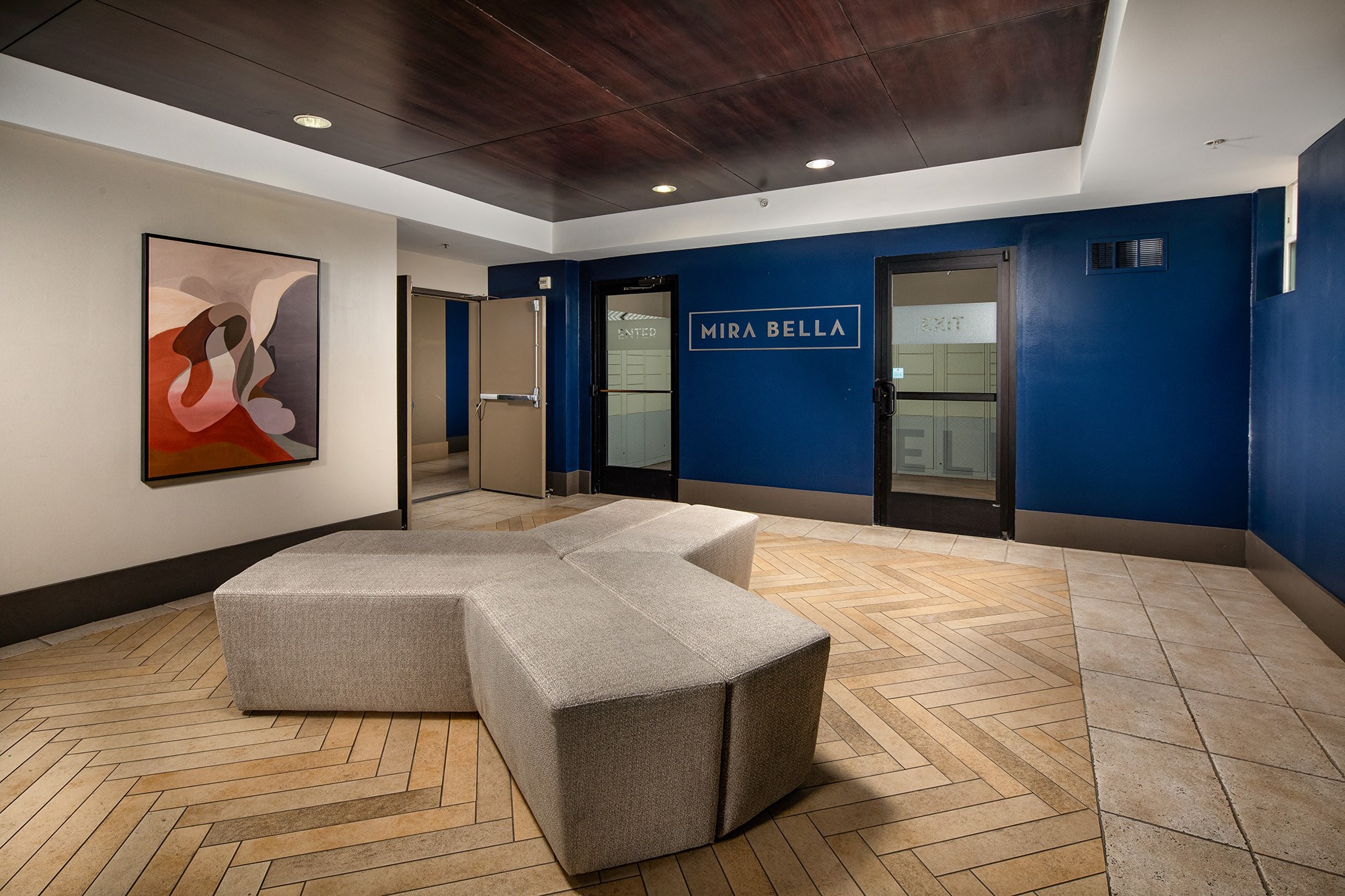 a room with a couch and a table in front of a door