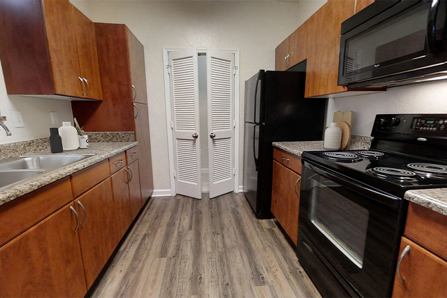 Reserve at Beachline Apartments in Orlando FL - Classic Apartments - Kitchens feature black appliances and plenty of storage