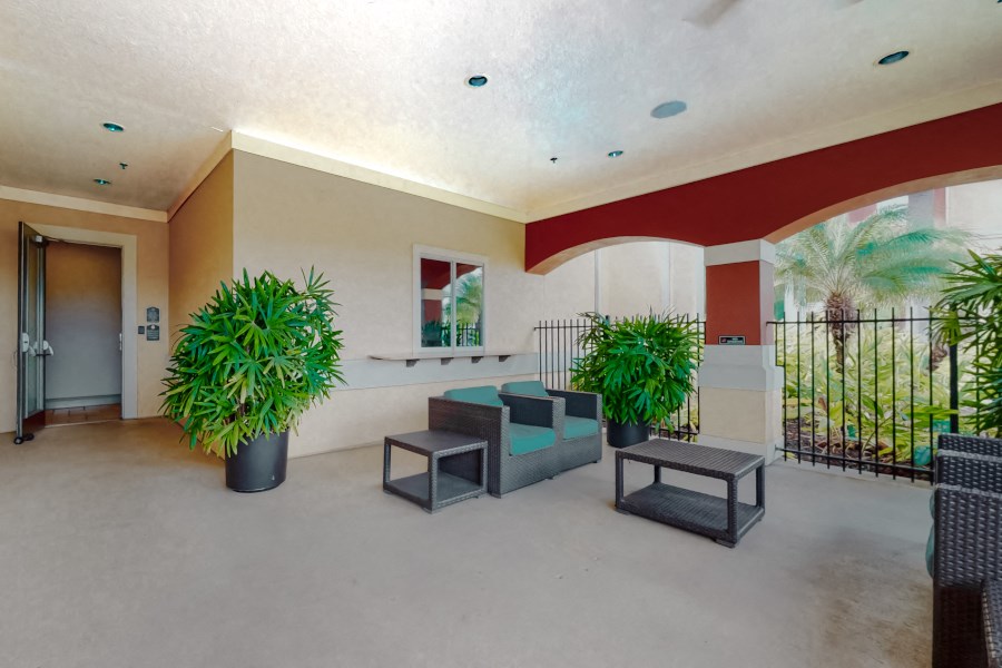 the lobby of a building with seating and potted plants