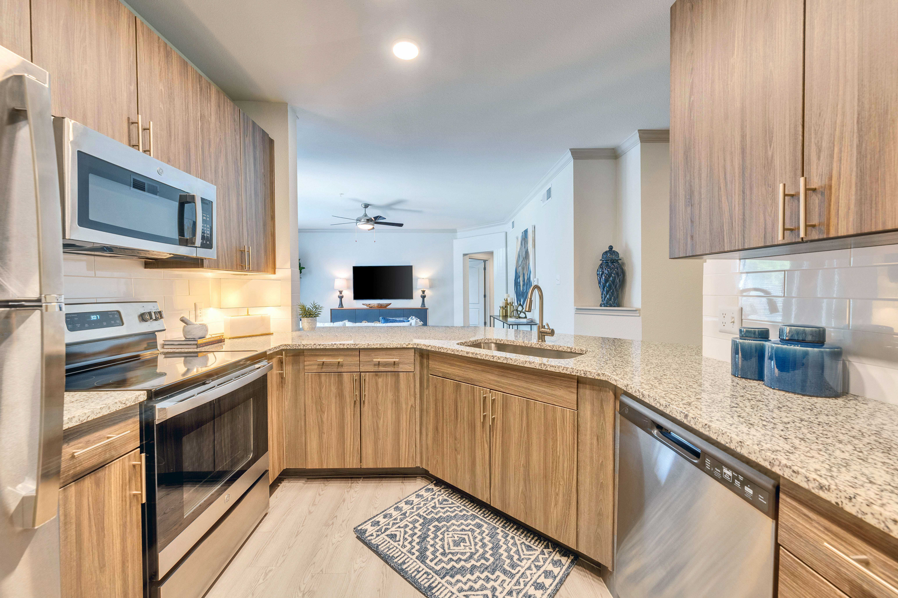 A modern kitchen with wooden cabinets and stainless steel appliances.
