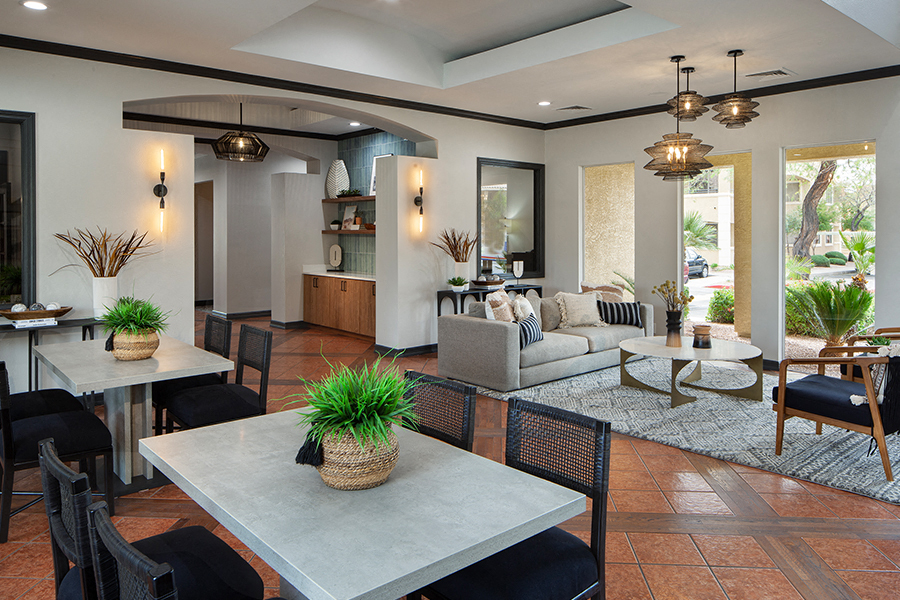 a living room and dining room with couches and tables