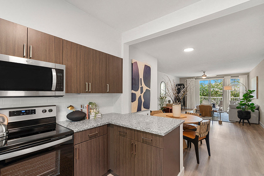 A modern kitchen with wooden cabinets and a stainless steel oven.