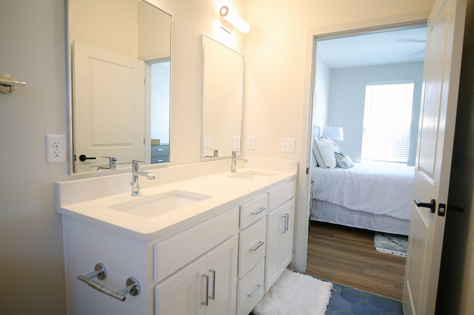 a white bathroom with a large mirror and a sink