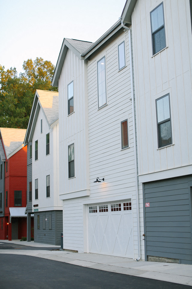 a row of white houses on the side of a street