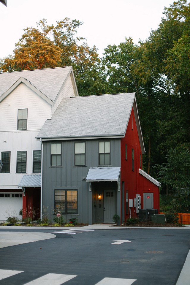 a red and white house and a white and gray building
