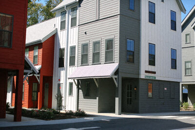 a row of white houses on the side of a street