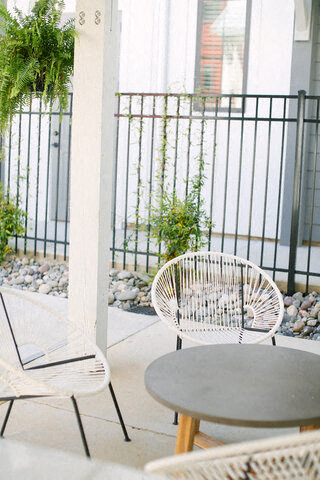 a patio with chairs and a table on a balcony