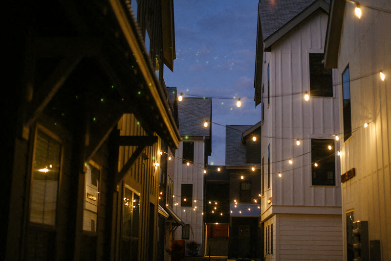 a city street at night with lights on the buildings
