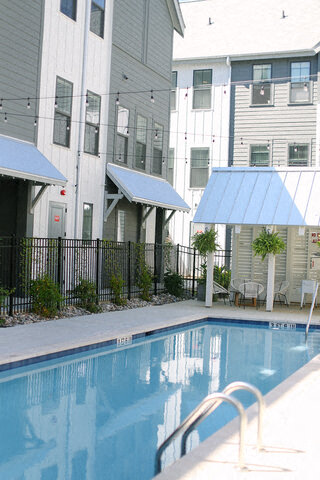 a swimming pool in front of an apartment building