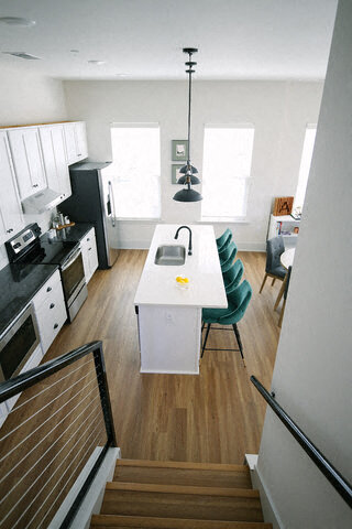 a kitchen with a sink and a white table