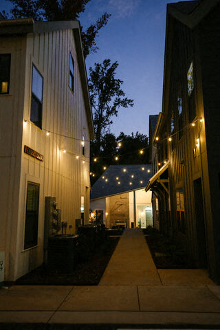 a sidewalk in front of a building at night