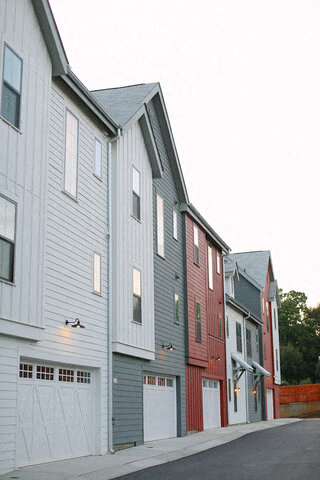 a row of houses on the side of a street