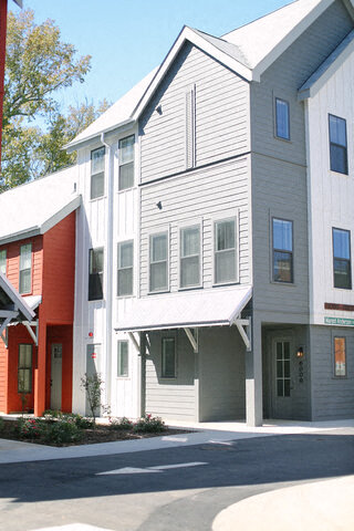 a white building is next to some other buildings