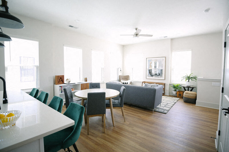 a living room and dining room with a table and chairs