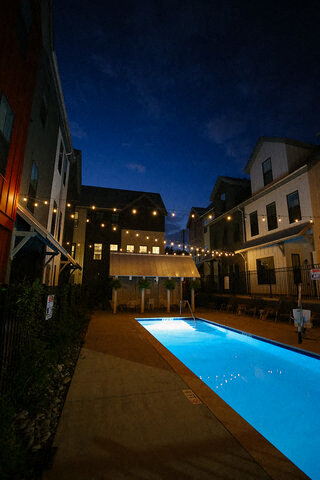 a swimming pool is lit up at night