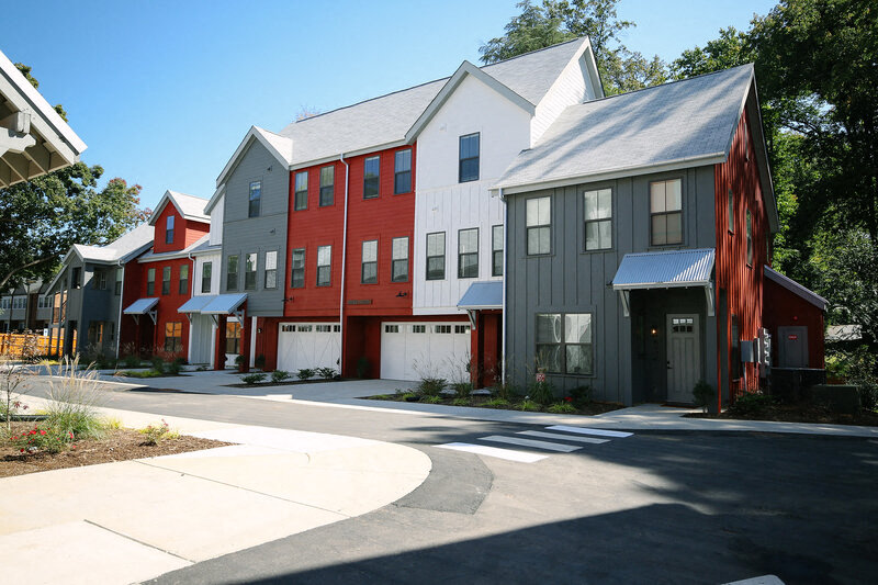 a row of colorful houses in front of a street