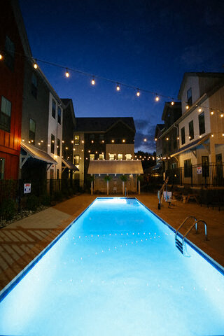 a swimming pool in the middle of a city at night