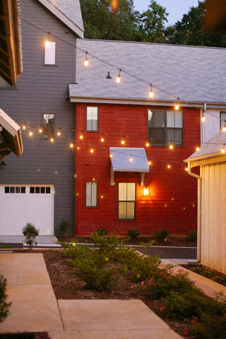 a red brick house with lights on it