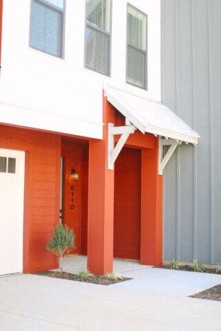 an orange and white building with a red door