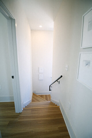 a staircase with a black hand rail in a house