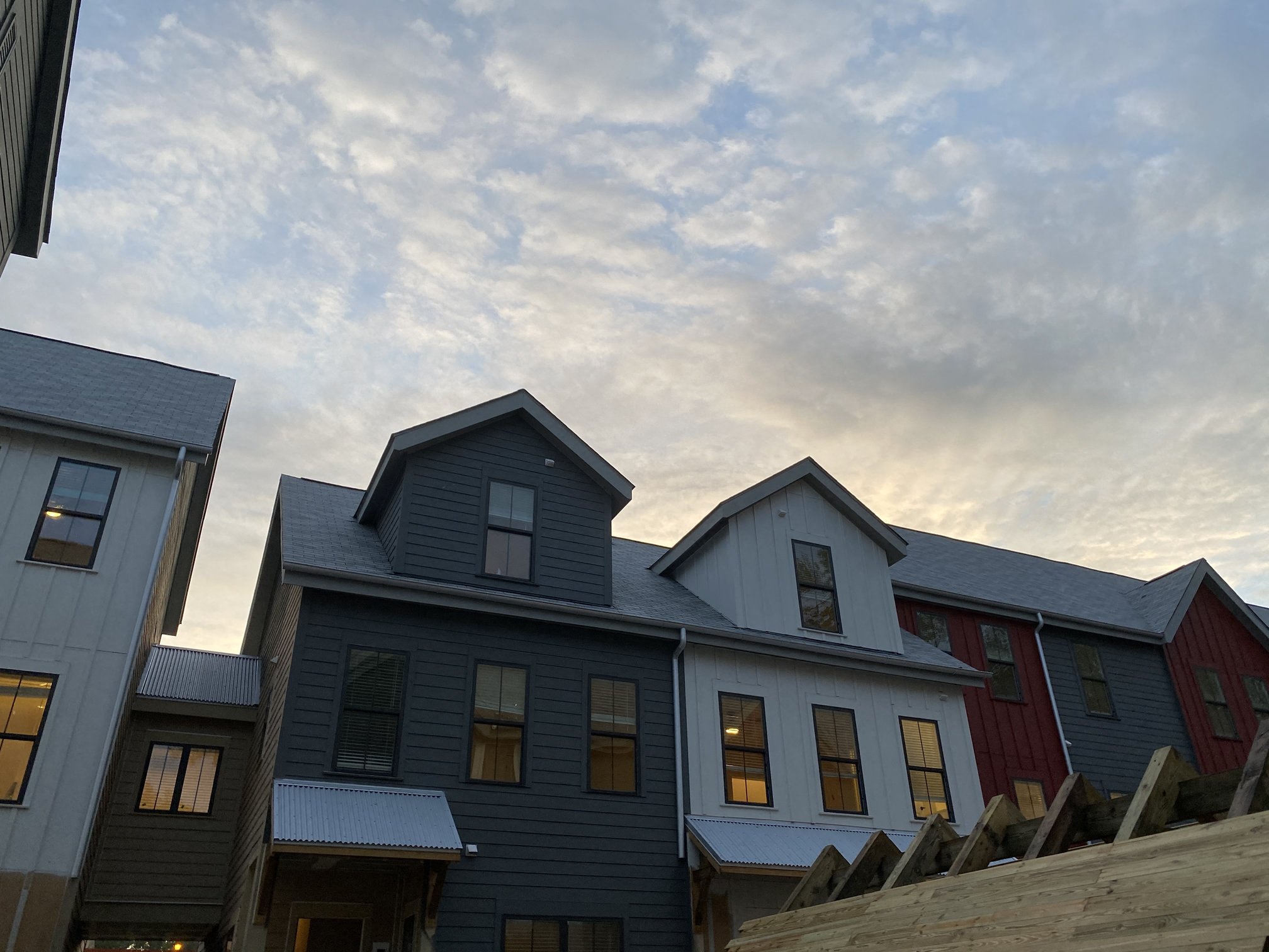 a row of houses against a cloudy sky