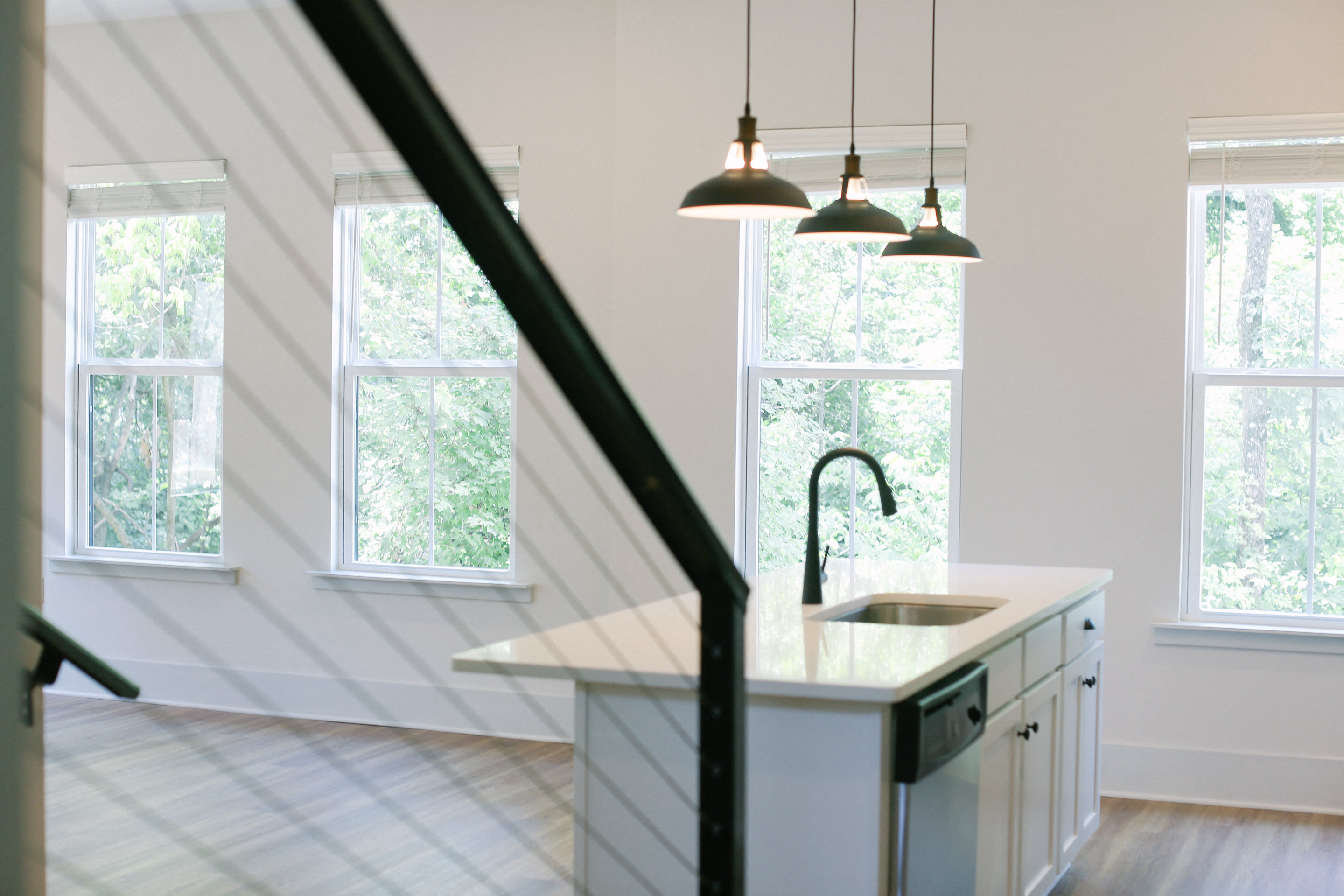 a view of the kitchen from the staircase in a new home