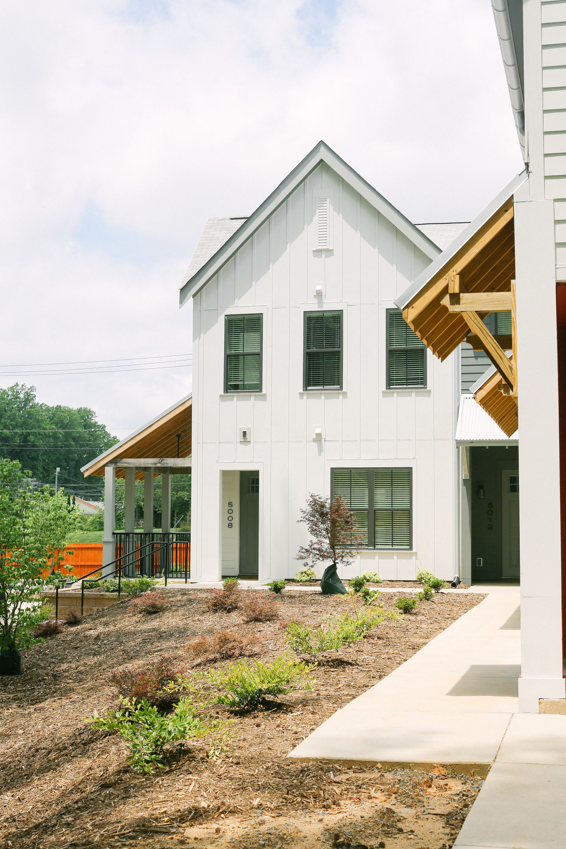 a white house with a yard in front of it