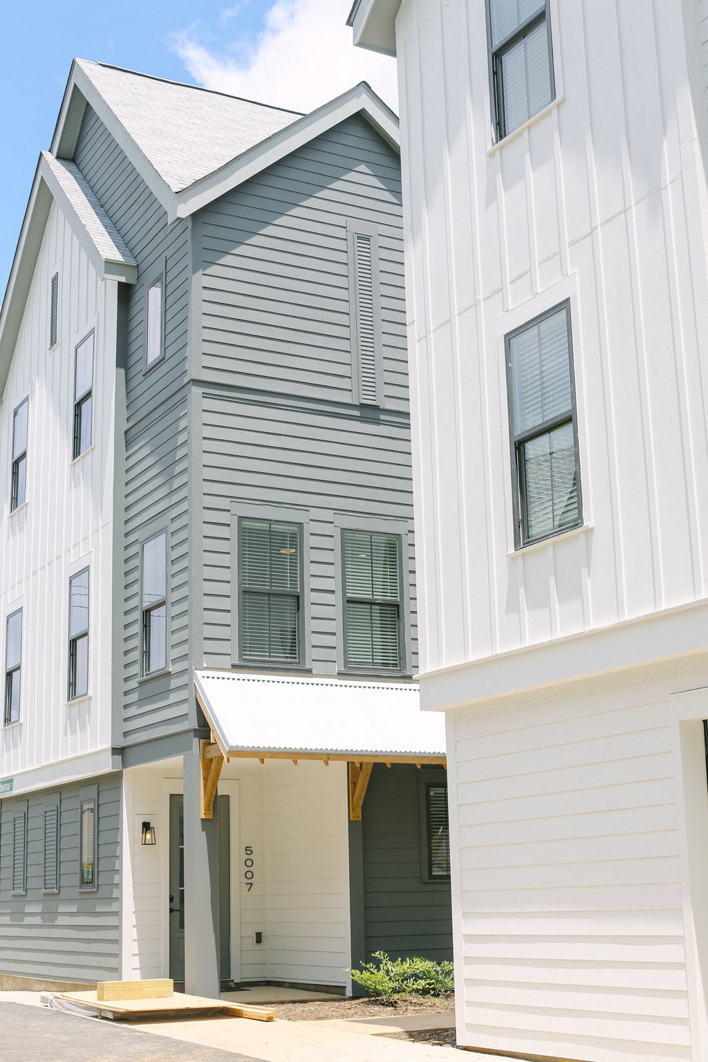 a row of white and gray buildings with an awning