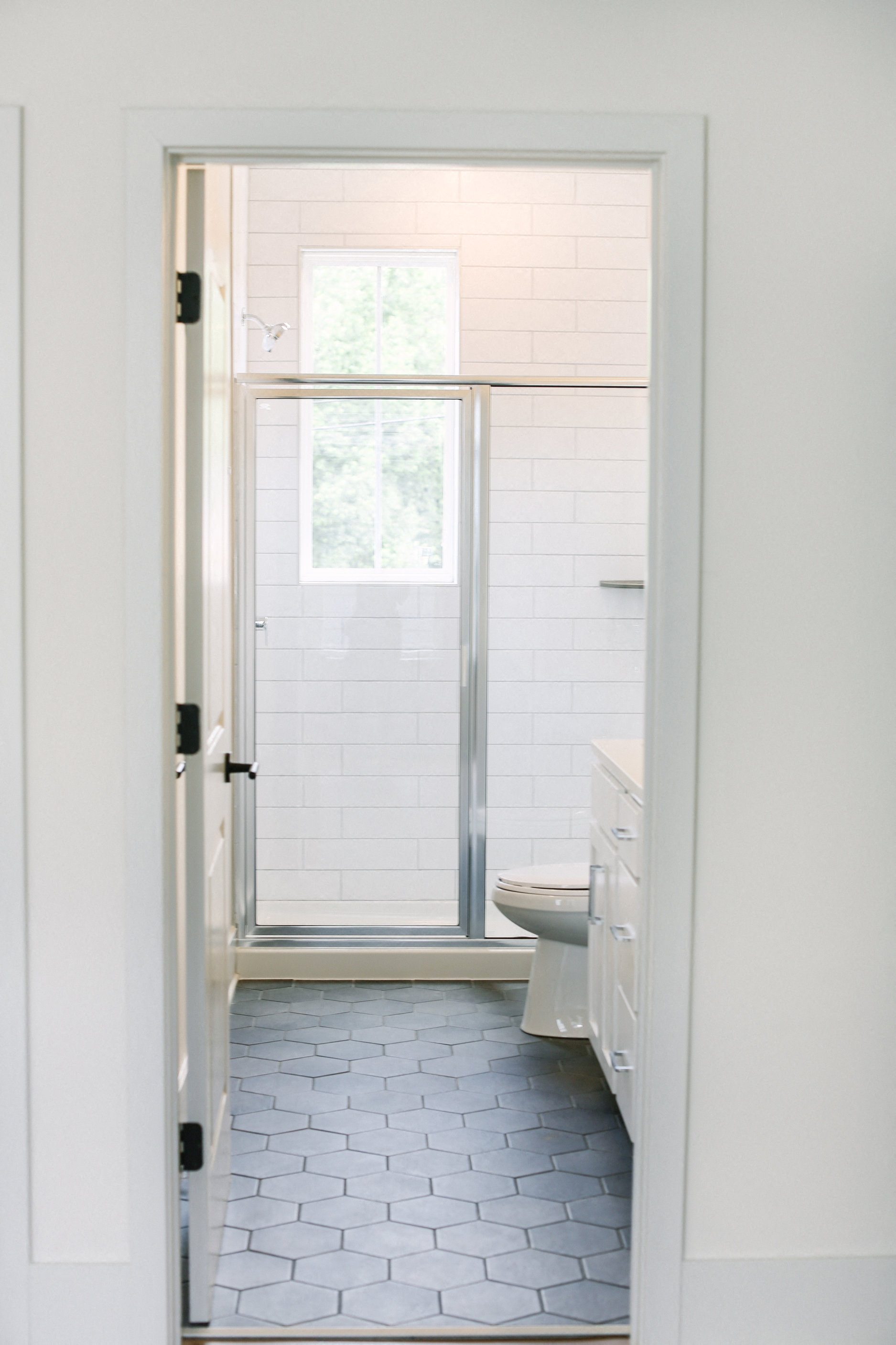 a small bathroom with a toilet and a glass shower door