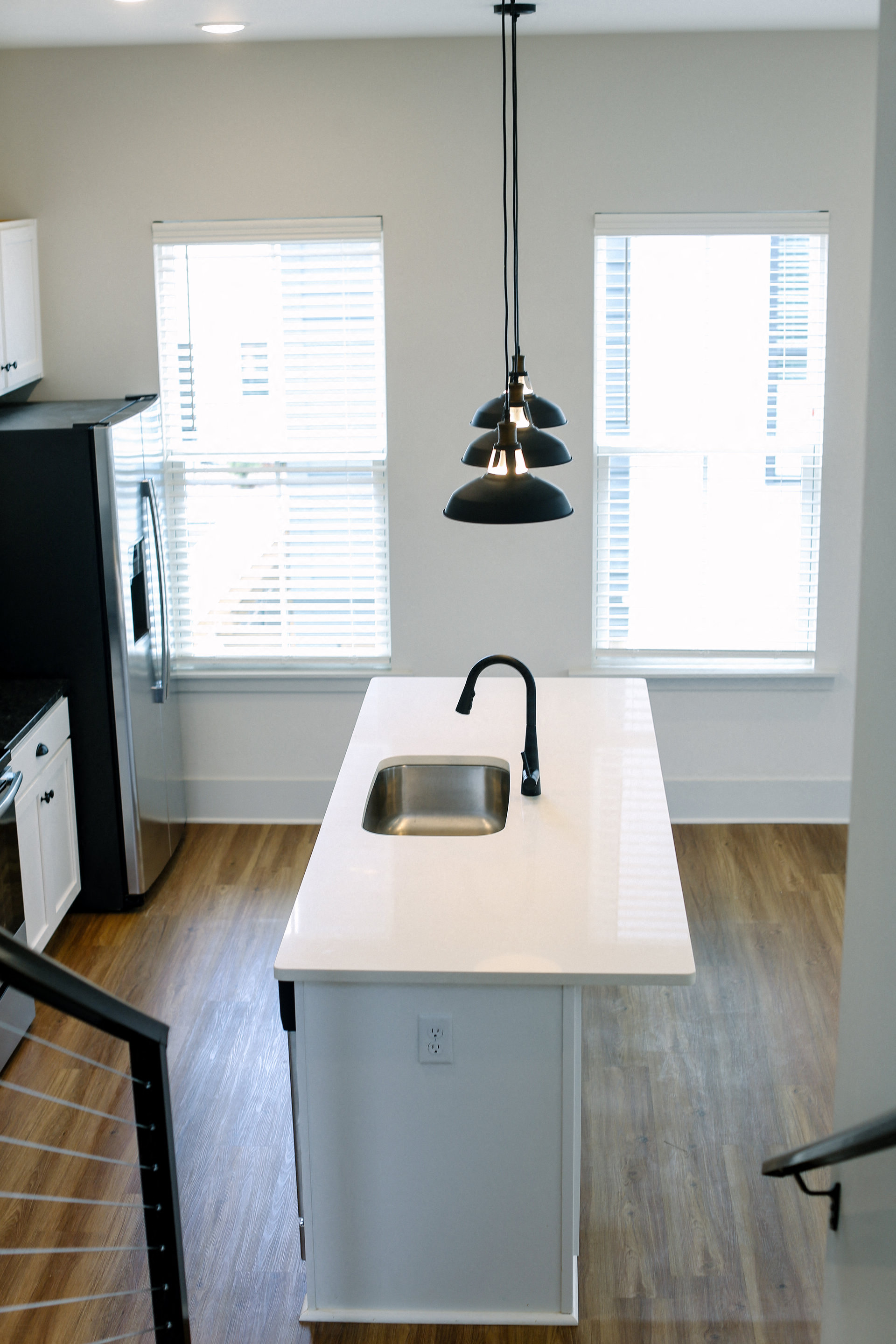 a kitchen with a white counter top and a sink