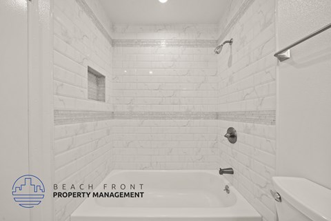 A white bathroom with a shower and a bathtub.