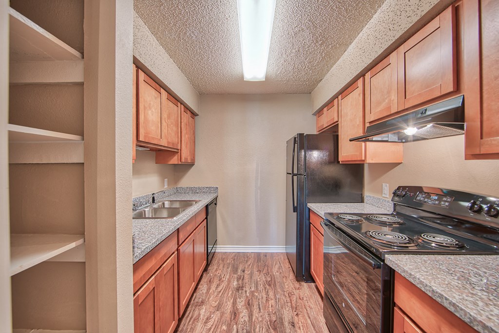 a kitchen with a stove and a refrigerator