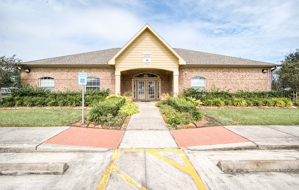 the front of a brick house with a sidewalk in front of it