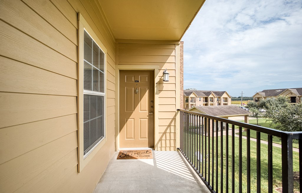 the view from the balcony of a home with a front door