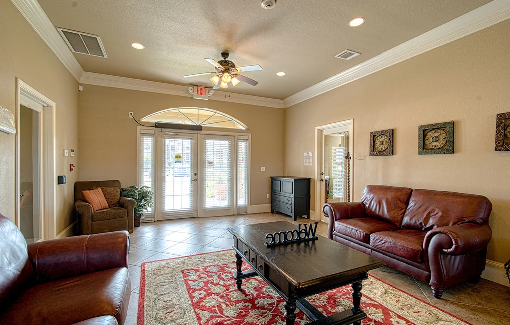 a living room with leather couches and a coffee table
