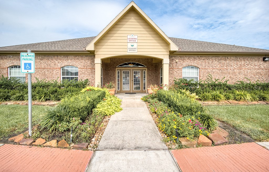 the front of a brick house with a sidewalk in front of it
