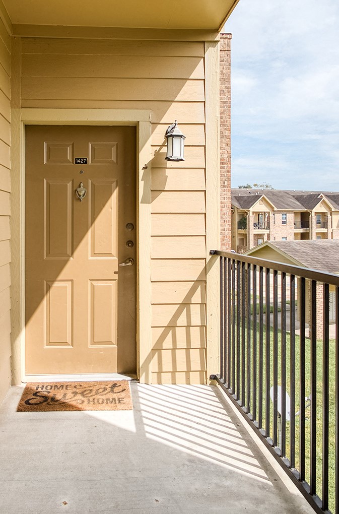 the front door of a house with a ramp to the porch