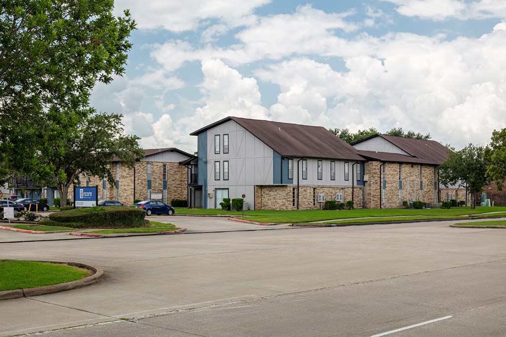 a street view of a building with a cloudy sky in the background