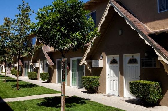 A row of houses with white doors and windows.