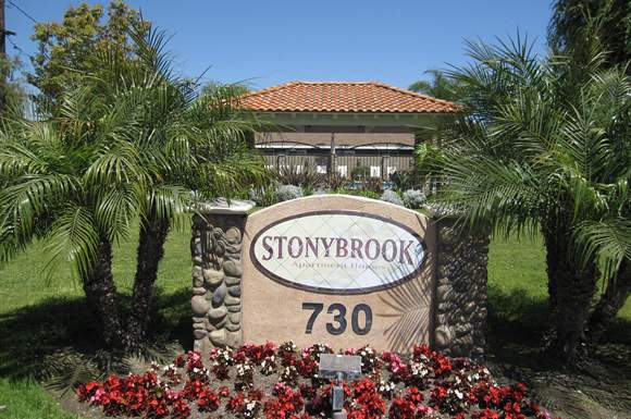 A sign that says Stonybrook 730 in front of a building.