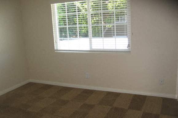 A room with a window and a checkered floor.