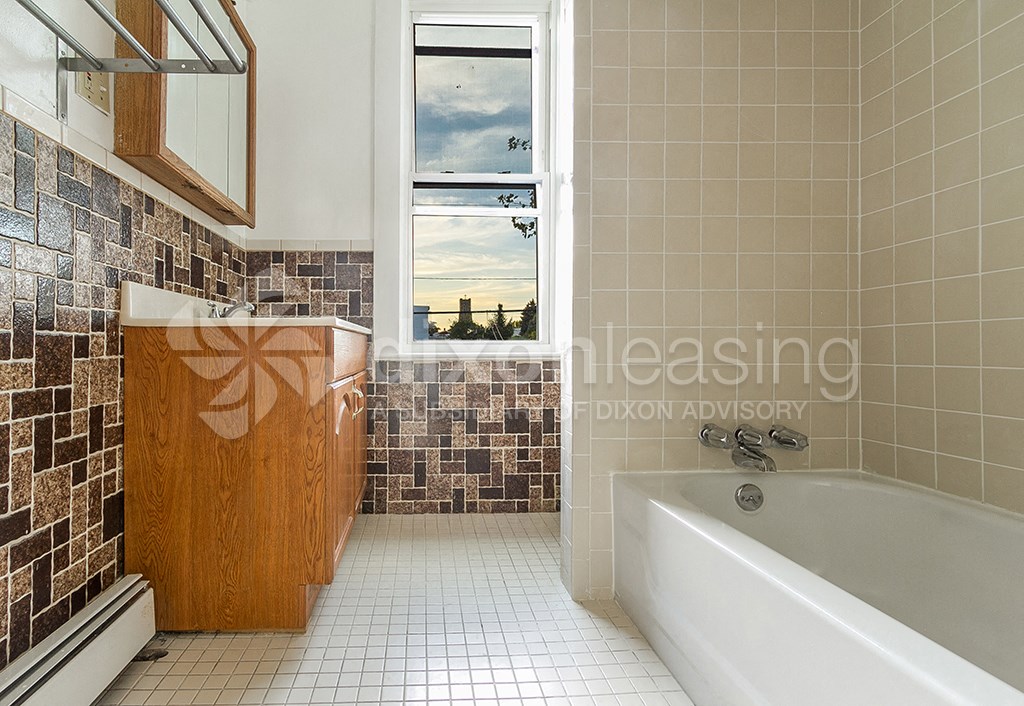 a bathroom with a bath tub and a window
