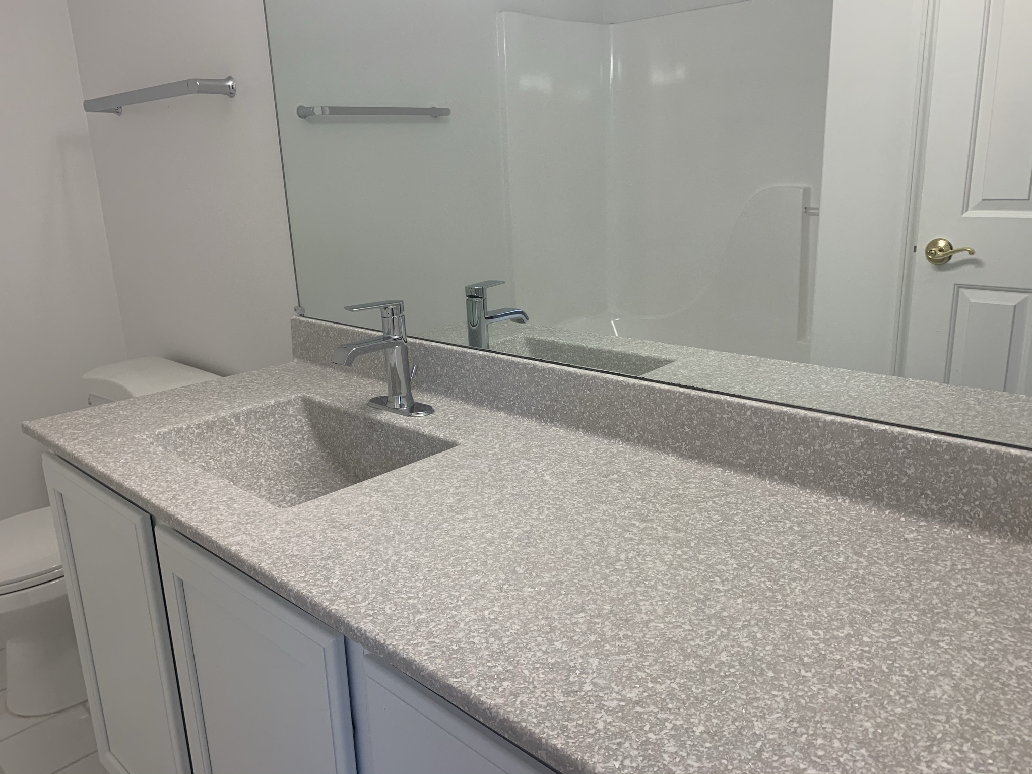 a white bathroom with a sink and a mirror