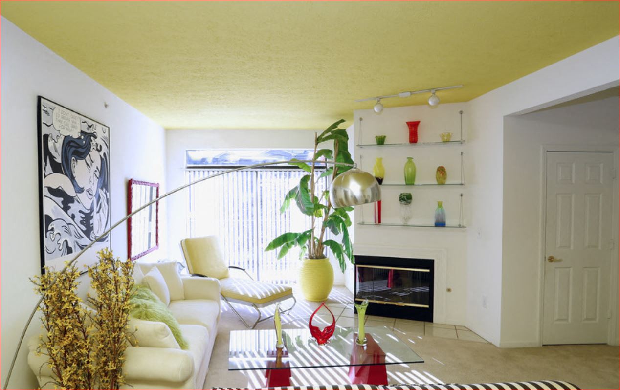a living room with a white couch and a fireplace